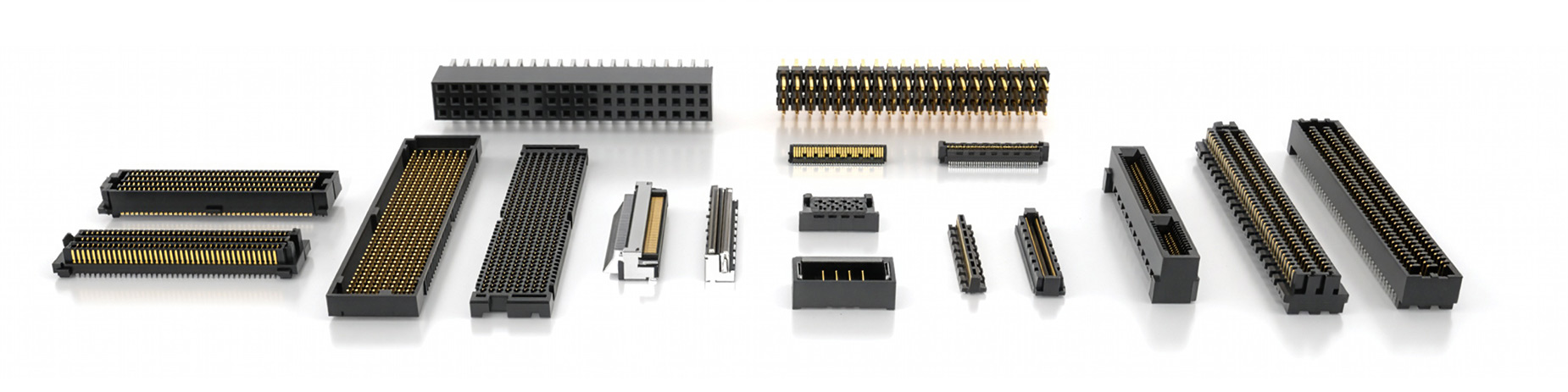 A variety of rectangular electronic connectors with gold pins, arranged in a row on a reflective white surface